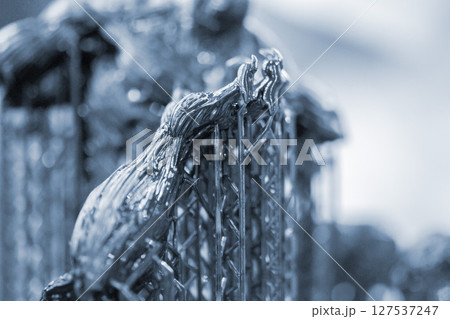 An object printed on a 3D printer from hardened rubber close-up. Model black color created on a 3D printer from hardened rubber under influence of ultraviolet light. SLA 3D printing. Stereolithography 127537247