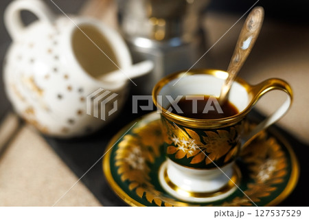 Elegant coffee experience in a cozy setting enhancing relaxation and conversation with rich aromas and flavors Elegant coffee experience in a cozy setting enhancing relaxation and conversation with rich aromas and flavors 127537529