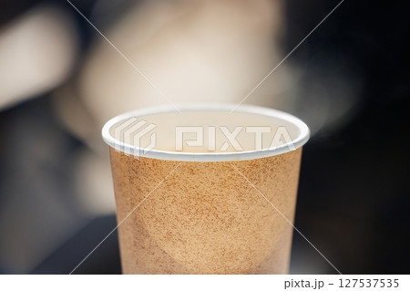 Enjoying fresh coffee in a cozy outdoor setting capturing the warmth of a serene morning atmosphere 127537535