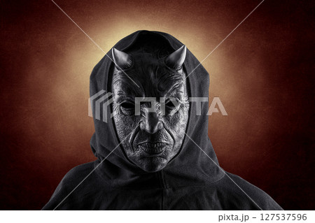 Portrait of a bad devil with horns on head over dark fiery background Portrait of a bad devil with horns on head over dark fiery background 127537596