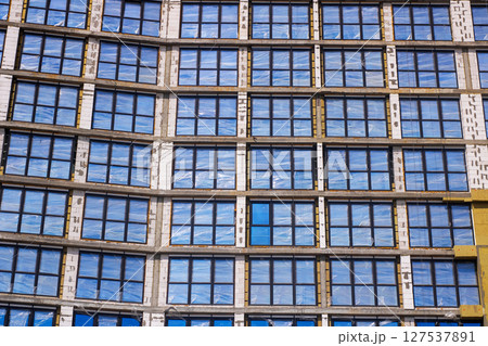 A new building with many windows is under construction 127537891