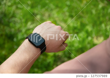Smart watch on hands of athlete for sports workout, heartbeat info or fitness progress on app. Personal trainer, exercise or closeup of person with timer to check or monitor gym data. Outdoors Smart watch on hands of athlete for sports workout, heartbeat info or fitness progress on app. Personal trainer, exercise or closeup of person with timer to check or monitor gym data. Outdoors 127537989