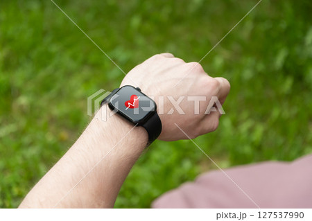 Smart watch on hands of athlete for sports workout, heartbeat info or fitness progress on app. Personal trainer, exercise or closeup of person with timer to check or monitor gym data. Outdoors Smart watch on hands of athlete for sports workout, heartbeat info or fitness progress on app. Personal trainer, exercise or closeup of person with timer to check or monitor gym data. Outdoors 127537990