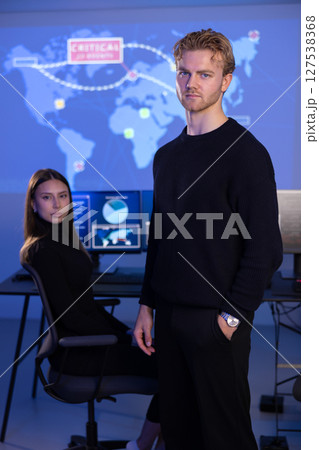 Male Cybersecurity Analyst and his team in Cyber Security Operation Center SOC handling Threats. Male Cybersecurity Analyst and his team in Cyber Security Operation Center SOC handling Threats. 127538368