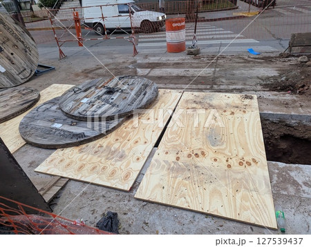 Cordoba, Argentina - May 08, 2025: Construction work. Laying underground utilities in the city center. Crossing the ditch for laying utilities Cordoba, Argentina - May 08, 2025: Construction work. Laying underground utilities in the city center. Crossing the ditch for laying utilities 127539437