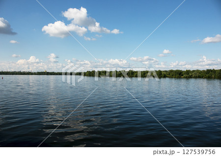 Panoramic view of Pridneprovsk city of Dnepr. Ukraine. Reflection of sky with clouds on water surface. 127539756