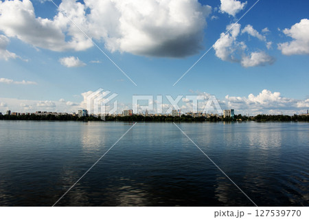 Panoramic view of the left bank of the Dnieper River. Ukraine. The city of Dnieper. Reflection of the sky with clouds on the water surface. 127539770