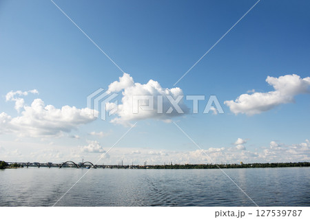 Panoramic view of the city of Dnepr. Ukraine. Reflection of the sky with clouds on the surface of the water. Panoramic view of the city of Dnepr. Ukraine. Reflection of the sky with clouds on the surface of the water. 127539787