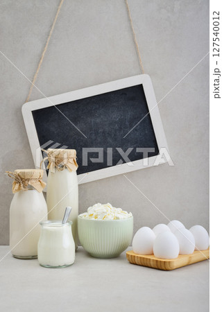 Various dairy products and eggs with framed chalk board Various dairy products and eggs with framed chalk board 127540012
