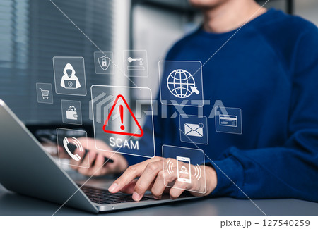 Scam Alert Warning with Cybersecurity Icons. Man holding smartphone while using laptop, warning sign for scams with icons online threats, phishing, cybersecurity, Unknown person, suspicious scammer, Scam Alert Warning with Cybersecurity Icons. Man holding smartphone while using laptop, warning sign for scams with icons online threats, phishing, cybersecurity, Unknown person, suspicious scammer, 127540259
