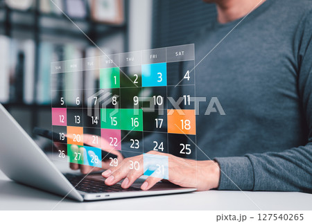 Time management and calendar planning concept. A person using laptop with digital monthly calendar, representing time management, event planning, appointment, agenda meeting, and schedule organization Time management and calendar planning concept. A person using laptop with digital monthly calendar, representing time management, event planning, appointment, agenda meeting, and schedule organization 127540265