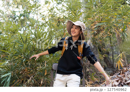 LGBT gay woman with backpack walk along forest path while hiking and camping on the weekend 127540962