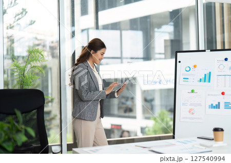 Business Professional Using Tablet in Modern Office Business Professional Using Tablet in Modern Office 127540994