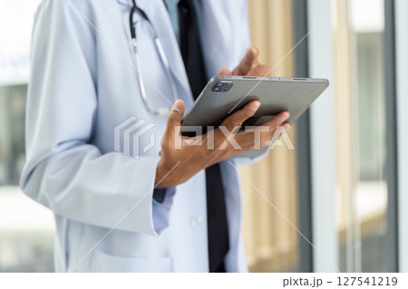 Digital Health Management. Doctor using tablet to access patient information. 127541219