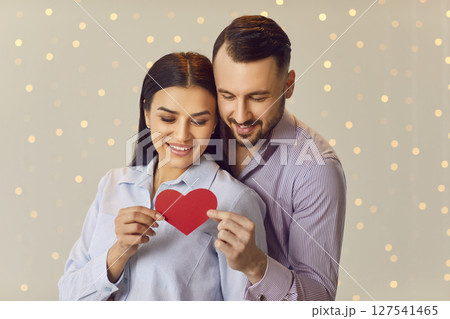 Smiling Happy Couple with a Red Heart Smiling Happy Couple with a Red Heart 127541465