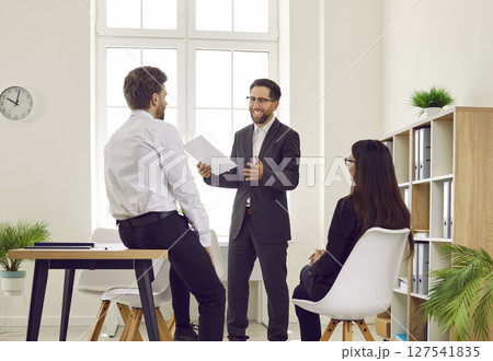 Team of business people together with their manager meeting and having a discussion 127541835