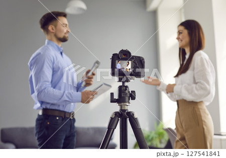 Modern digital video camera recording journalistic interview in television studio Modern digital video camera recording journalistic interview in television studio 127541841