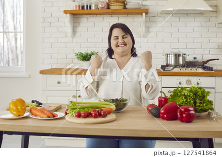 Overweight woman is motivated for weight loss and eats only healthy food on diet Overweight woman is motivated for weight loss and eats only healthy food on diet 127541864