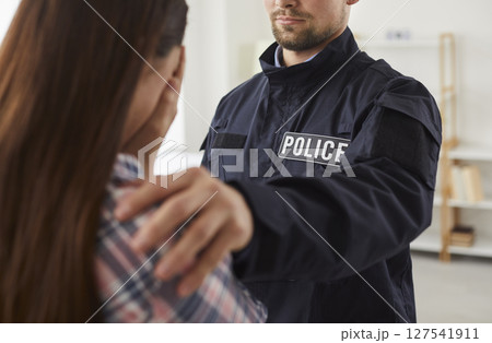 Policeman interrogating woman witness of crime, house burglary Policeman interrogating woman witness of crime, house burglary 127541911