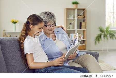 Senior couple sitting at the table and calculating finances or taxes at home. 127541997