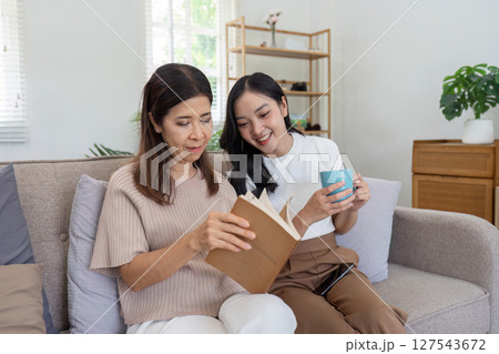 mature daughter and mother sitting together in the morning. mature daughter and retired mother spend weekend together mature daughter and mother sitting together in the morning. mature daughter and retired mother spend weekend together 127543672