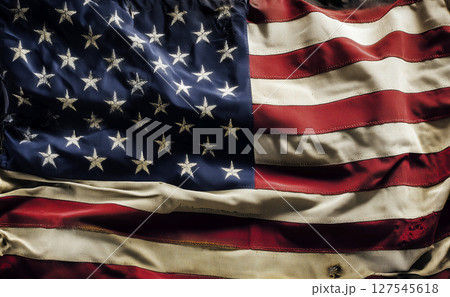 Close-up of a weathered and wrinkled American flag, showcasing the texture of its fabric and the enduring spirit of patriotism. Close-up of a weathered and wrinkled American flag, showcasing the texture of its fabric and the enduring spirit of patriotism. 127545618