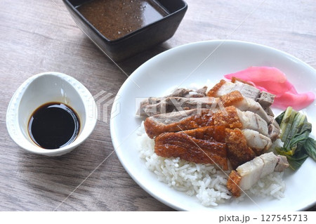 slice roasted duck couple crispy pork topping rice with pink pickled ginger and boiled cabbage dressing sweet soy sauce on plate slice roasted duck couple crispy pork topping rice with pink pickled ginger and boiled cabbage dressing sweet soy sauce on plate 127545713