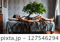 A tree growing from a human body with burrowing roots 127546294