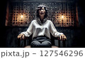 A woman sits with her eyes closed in a chair in an old laboratory, with several wires connected to her head. 127546296