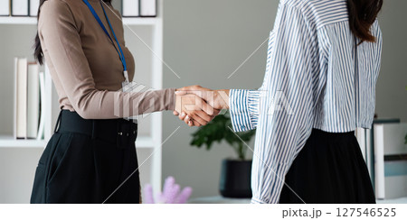 Young business people shaking hands after a successful deal Working together, Handshake, Collaboration, teamwork 127546525