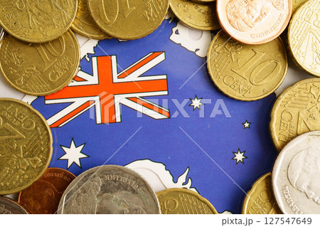 Australia flag on coin and banknote money, finance trading investment business currency concept. Australia flag on coin and banknote money, finance trading investment business currency concept. 127547649