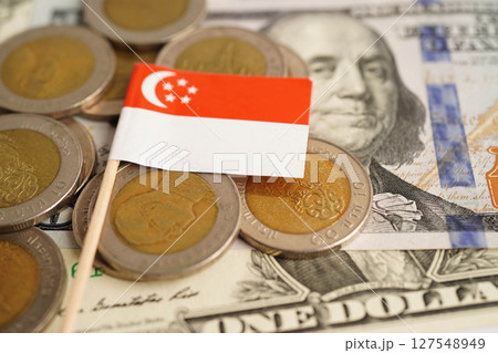 Singapore flag on coin and banknote money, finance trading investment business currency concept. Singapore flag on coin and banknote money, finance trading investment business currency concept. 127548949