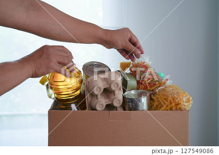 Foodstuffs in donation box for volunteer to help people. 127549086