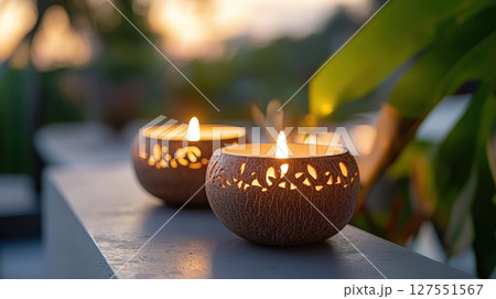 Glowing Coconut Shell Candles with Intricate Carvings Adorning a Tabletop Glowing Coconut Shell Candles with Intricate Carvings Adorning a Tabletop 127551567