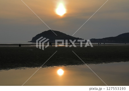 オレンジ色の夕陽を映した三豊父母ヶ浜の潮だまり 127553193