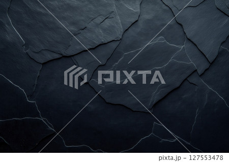 Exploring the Intricate Textures of a Dark Black Grunge Concrete Wall Illuminated by Ambient Light 127553478