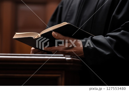 Lawyer Preparing for Court With Law Book in a Solemn and Elegant Courtroom Setting 127553480
