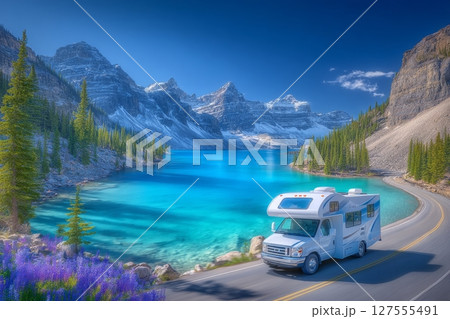 A Spring evening view of Icefields Parkway at Bow Lake showcases the parkway stretching out towards the lake, with BowCrow Peak, Crowfoot Glacier, and Crowfoot Mountain towering in the background of 127555491