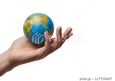 Hand holding a miniature globe mockup isolated on white background, for global travel, education themes, or eco-awareness visuals. 127556687