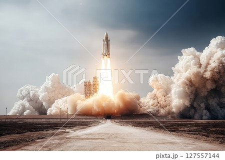 Rocket launch with bright flames and smoke. Powerful spacecraft ascends from desert launchpad, creating dramatic sky view. Ideal for space exploration or mission visuals. 127557144