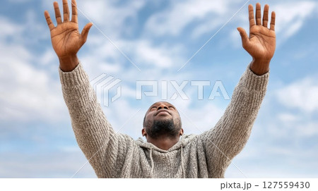 Man Raising Hands in Prayer and Gratitude 127559430