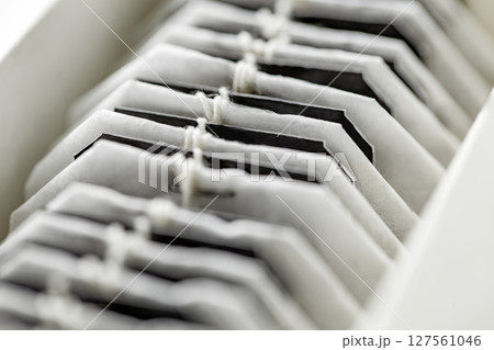 Tea bags are stacked in row in box, selective focus 127561046