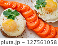 Fried eggs with meat cutlets and carrots with spices and sesame seeds, top view, close-up selective focus 127561058