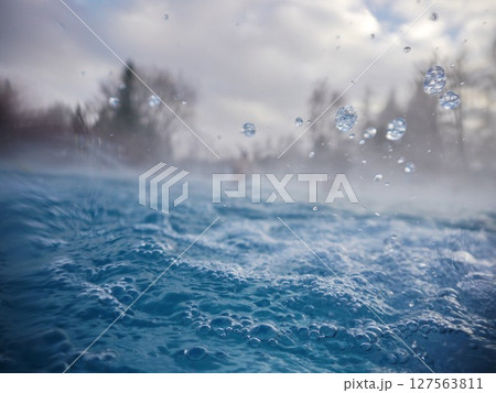 A body of water with a lot of bubbles and splashes A body of water with a lot of bubbles and splashes 127563811