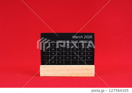 March 2026 chalkboard calendar on red color background. March 2026 chalkboard calendar on red color background. 127564105