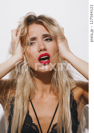 emotions and feelings concept - stunning blonde woman in delicate lingerie, experiencing pure passion, her mouth open, eyes shut, basking in bright studio light against a clean white background emotions and feelings concept - stunning blonde woman in delicate lingerie, experiencing pure passion, her mouth open, eyes shut, basking in bright studio light against a clean white background 127564122