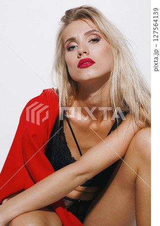 emotions and feelings concept - stunning blonde in delicate lingerie, moaning in ecstasy, lost in pure pleasure, her radiant skin illuminated by bright white light as she fully surrenders 127564139