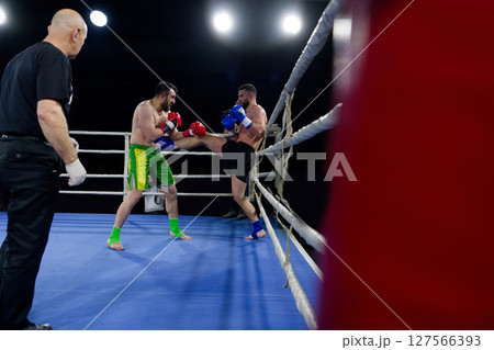 Fierce boxing match showcases athletes' power and skill. 127566393