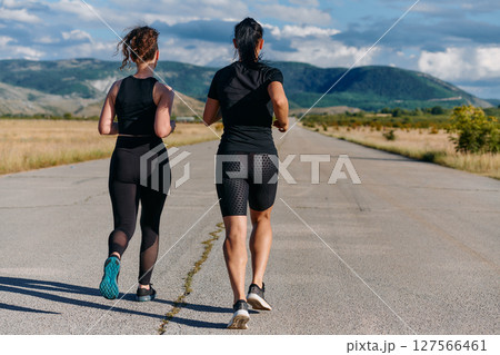 Two Friends Running Together on a Sunny Day, Preparing for Life's Extreme Challenges 127566461