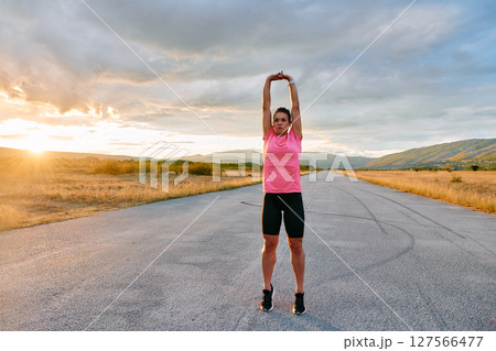 Athlete Stretching at Sunset After Intense Run Athlete Stretching at Sunset After Intense Run 127566477